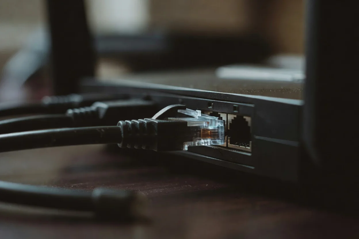 An ethernet cable connector in a router port, extreme close-up