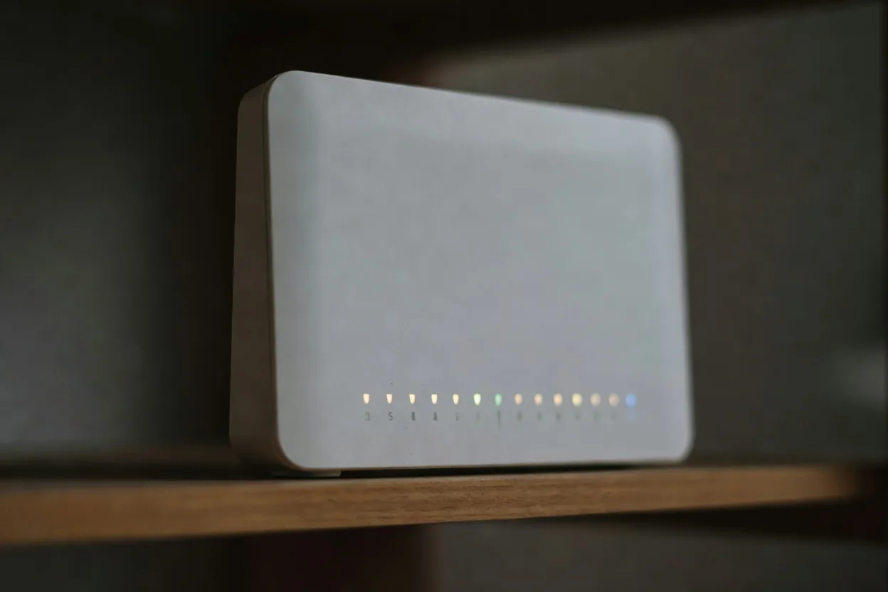 A home router with softly glowing status lights